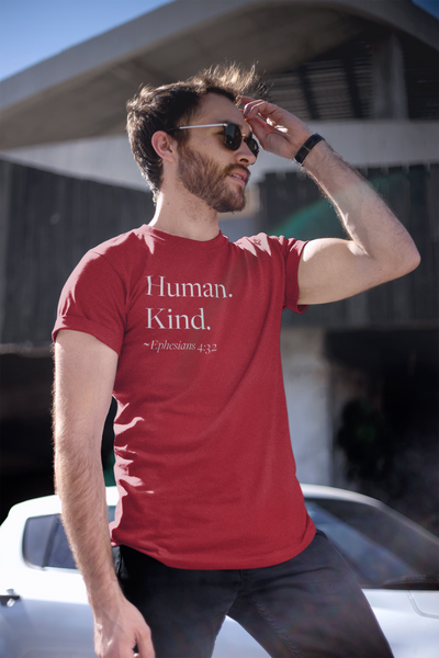 Man wearing red Human Kind unisex t shirt